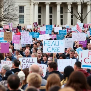 Crowd of healthcare workers protesting budget cuts outside the state house.